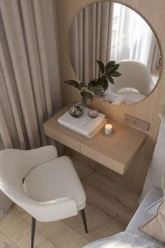 a white chair sitting in front of a mirror on top of a wooden table next to a bed