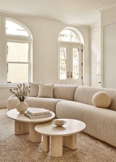 a living room filled with furniture and windows