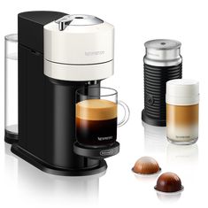 an espresso machine with two cups next to it and three different types of coffee