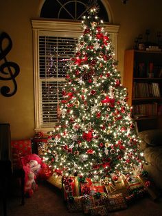 a lit christmas tree in a living room