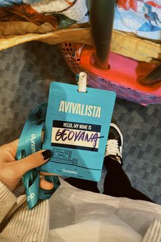 a person holding up a blue book with the words avavisistaa on it