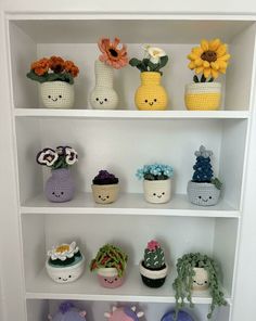 the shelves are filled with crocheted flowers and potted plants in vases