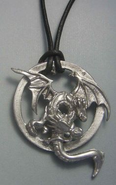 Two-headed dragon pendant, with leather cord included ( 45-50 cms or more if you need) called Anfisbaena. Dragon anfisbaena pendant is a talisman regenerator of health. Dragon pendant available in silver and gold. You can earn in two ways with the bead of leather, traditional way or with an informal knot. Dimensions of the dragon anfisbaena pendant: 3.9 cms x 3.1 cms ORIGIN OF THE DRAGON ANFISBAENA Anfisbaena pendant is a dragon with possible origin in the north of Africa - although its cult is Silver Dragon Design Jewelry For Fantasy Events, Two Heads, Dragon Pendant, Silver 925 Necklace, Necklace Charm, A Dragon, Fantasy Jewelry, Dragon Art, Leather Cord