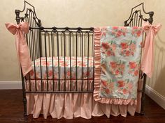 a baby crib with pink and orange flowers on it