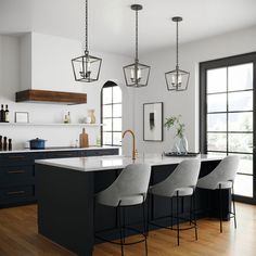 a kitchen with black cabinets and white counter tops, along with bar stools that match the hardwood flooring