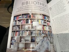 an open book showing the contents of a living room with bookshelves and furniture