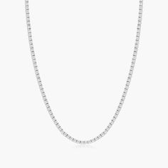 This tennis necklace is the epitome of elegance. A row of scintillating round brilliant diamonds are set on four prong baskets and lined up perfectly to create the most glamorous diamond necklace. A box clasp with security latch closes and secure the necklace in place. Formal White Necklace With Box Chain, Classic White Diamond Necklace With Polished Finish, Timeless Sterling Silver Tennis Necklace For Formal Occasions, Classic Tennis Necklace With Baguette Diamond Cut, Classic Diamond White Necklace With Box Chain, Classic Diamond Necklace With Box Chain For Anniversary, Classic Necklace With Diamond White Box Chain, Formal White Gold Diamond Necklace With Box Chain, Timeless Single Strand Tennis Necklace For Formal Occasions