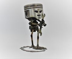 a metal robot holding a wrench in his hand