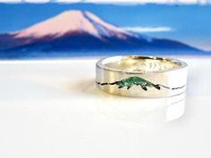 The Summit Mountain Ring was designed and inspired by the incredible accomplishments of climbers and mountaineers. This bespoke ring is a personal favorite within my ML Mountain Collection. Almost a reliquary ring in ways and a fantastic way to keep that summit close to you always. Strength, endurance, patience, knowledge...all of the things that keep you going in the mountains, can stay with you.  Handcrafted from recycled precious metal. Any gemstone or piece of summit rock from your climb, or a pebble from a special place can be set within the mountain peak or summit.  A memorable heirloom ring to cherish for a lifetime.  How You Order Your Personalized Summit Mountain Ring... After you've selected the metal and your ring size, please send a message through "Etsy Convos" with a image of Mountain Rings, Silver Mountain Ring, Inlay Wedding Band, Heirloom Ring, Fuji Mountain, Mountain Ring, Heirloom Rings, Mountain Jewelry, Platinum Wedding Band