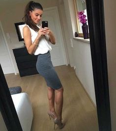 a woman is taking a selfie in the mirror with her cell phone and high heels