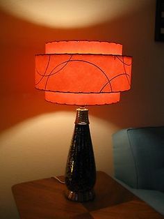 a lamp that is sitting on top of a table in front of a couch and chair