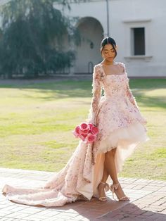 a woman in a wedding dress standing on the ground