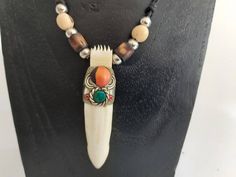 - Description - Handmade necklace made by real amazonian crocodile teeth. A truly unique and rare piece which takes a lot of work to create. Waterproof so you can safely wear at the beach. - Size - P-1 :67cm , Pendant height : 7.50cm. P-2 :fully adjustable. Pendant height : 8cm - Shipping info - This piece is ready and will be sent to the shipping company ems within 1-3 days, depending on the existing workload at the time of the order. In the case of a delay or issue, you will be informed in adv Crocodile Teeth, Tooth Pendant, Tooth Necklace, Shipping Company, Handmade Necklace, Cyprus, Handmade Necklaces, At The Beach, Turquoise Bracelet