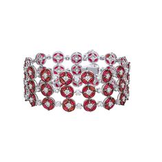 Unbelievably gorgeous 18K bracelet finely crafted in 18K white gold. This amazing bracelet features 3 row of rubies and diamonds. The rubies and diamonds repeat in a design of 4 marquise cut ruby surrounding one diamond spaced between one round diamond. The immaculate design highlights the alluring beauty of the genuine rubies. All the stones are set in prong, the tips of the prongs holding these marquise cut very fine rubies are black rhodium plated. The 180 rubies measure to a total weight of Luxury Ruby Marquise Jewelry, Luxury Marquise Cut Ruby Ring With Vvs Clarity, Luxury Marquise Ruby Jewelry, Luxury Marquise Cut Ruby Ring Fine Jewelry, Luxury Pink Ruby Bracelets, Luxury Ruby Bracelets For Wedding, Luxury Ruby Bracelets For Festive Occasions, Luxury Red Diamond Bracelet, Red Luxury Diamond Bracelet