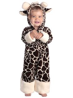 a little boy in a giraffe costume standing with his hands on his chest