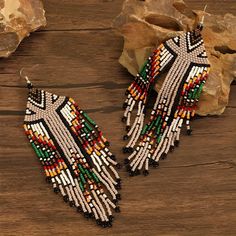 Elevate your holiday wardrobe with these boho-inspired dangle earrings, showcasing a unique geometric shape and vibrant beadwork. Perfect for any vacation, these lightweight and hypoallergenic earrings are designed to keep you stylish and comfortable all day long. Add a dash of color and artistic flair to your outfits with these exquisite ear ornaments. Why Buy: 🧡 Boho Elegance: These earrings feature a stunning geometric design with a colorful bead pattern, perfect for adding a touch of bohemi Beaded Multicolor Chandelier Earrings, Multicolor Beaded Chandelier Earrings, Bohemian Dangle Earrings With Large Beads, Festival Multicolor Beaded Fringe Chandelier Earrings, Multicolor Beaded Southwestern Earrings, Bohemian Multicolor Beaded Earrings For Summer, Multicolor Southwestern Beaded Earrings, Traditional Multicolor Beaded Fringe Tassel Earrings, Traditional Multicolor Beaded Tassel Earrings