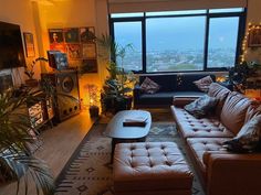 a living room filled with furniture and a large window next to a flat screen tv