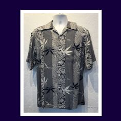 "1940s vintage reproduction by \"Kona Bay\" rayon Hawaiian shirt. The shirt's rayon fabric has a white base color and features images of leaves and vertical stripes in white and navy blue. The shirt has a pointed loop collar, five button down front, one patch pocket and short sleeves. The label reads \"Kona Bay\" an Hawaiian Original and the shirt is in new, unworn condition. Hand washable. Cold water only. The shirt is currently available in size large Please see measurements below for proper f Classic Patterned Summer Tops, Classic Patterned Tops For Summer, Classic Rayon Summer Shirt, Vintage Vertical Striped Summer Tops, Vintage Vertical Stripes Tops For Summer, Classic Rayon Shirt For Summer, Vintage Vertical Striped Tops For Summer, Classic Short Sleeve Patterned Tops, Vintage Tops With Vertical Stripes For Summer