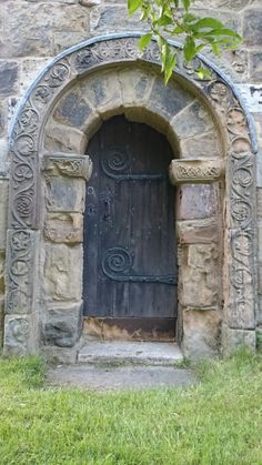 an old wooden door in the side of a stone building