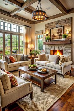 a living room filled with furniture and a fire place in the middle of a room