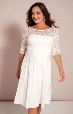 Beautifully designed using bold stretch floral lace, our Lucia short all white maternity dress is super luxurious. You’ll love the simple elegance of the lace sleeves and bodice combined with our finest heavyweight micro modal fabric that exudes bridal style. The knee length skirt has a gentle swish to it while the sheer sleeves and neckline are delicately detailed adding a modern vintage feel. City or country wedding, accessorise with our luxurious faux silk ivory sash (not included), a beautif Elegant Dresses With Lace Sleeves For Wedding Night, Elegant Wedding Night Dress With Lace Sleeves, Maternity Wear Dresses With Lace Trim, White Lace Dress With Lace Sleeves For Bridesmaid, Maternity Dress With Lace Bodice, Maternity Dress With Delicate Lace, Elegant Lace Top Dress For Mother Of The Bride, Maternity Lace Dress With Lace Bodice, Elegant White Maternity Dress