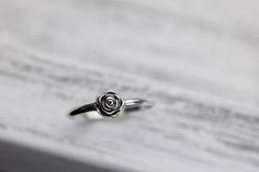 Someone once said that flowers are God's sweetest creations without a soul, and we couldn't agree more and the rose is the most beloved flower of all time. Roses symbolize love and happiness. This dainty rose ring is the perfect way to express your love, friendship or admiration for your beloved! Crafted from sold sterling silver. This ring is beautiful on its own or looks lovely stacked with my sterling silver vine ring linked below. ✥ Sterling Silver ✥ Available in sizes 3-10 ✥ Beautifully box Flower Shaped Rings With Roses For Gift, Dainty Rose Colored Rings As Gift, Delicate Rose Colored Rings For Gift, Dainty Rose Design Flower Promise Ring, Delicate Rose Color Rings For Gifts, Adjustable Rose Design Flower Ring As Gift, Adjustable Rose Design Flower Ring For Anniversary, Round Flower Ring With Rose Design For Gift, Elegant Flower Ring With Roses For Gift