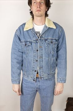 "For sale is a vintage denim trucker jacket.  Collar spreads out much more than the current jackets do for a cool vintage look.  Size large, relaxed fit through chest but strong taper to waist Measurements laid flat: Pit-to-pit chest width: 25\" Width at bottom hem: 21.5\" Length from top of shoulder: 26.5\" Sleeve length from edge of shoulder: 24\" Model is 6'5\" 180lb, wears the following sizes: Dress shirt: 15.5\" neck, 36.5\" sleeve Suit jacket: 42L - 44L depending on cut Pants waist: 32-34\", 33\" ideal Pants inseam: 34-36\", 36\" ideal Shirt size, letter: Medium-large, medium-tall ideal" 90s Style Cotton Denim Jacket For Winter, Vintage Washed Outerwear For Streetwear, Vintage Denim Outerwear For Winter, Vintage Winter Denim Outerwear, Retro Dark Wash Outerwear For Streetwear, 90s Denim Jacket For Winter Streetwear, Vintage Winter Outerwear In Medium Wash, 90s Winter Denim Jacket For Streetwear, 90s Light Wash Outerwear For Streetwear