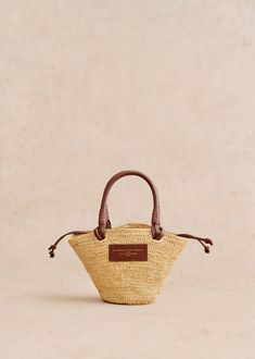 Made in our atelier in Madagascar;Basket carried on the shoulder;Hand-woven raffia exterior;Handle not adjustable;Carried on the shoulder and in the hand;Closes with leather ties;Cotton lining;Length of handles: 10 cm / 46 cm / 3.9 in / 18.1 in;Weight of the bag: 0,4 kg / 14.1 oz;Dimensions: 15 x 31 x 10 cm / 5.9 x 12.2 x 3.9 in Ochre Flowers, Raffia Embroidery, Mini Basket, Raffia Bag, Woven Raffia, Basket Bag, Best Bags, Dress Jewelry, Spring 2024