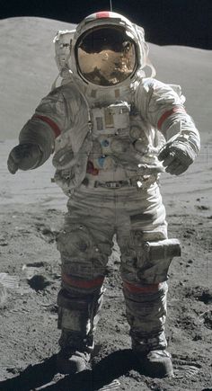 an astronaut standing on the moon with his hands in his pockets and looking at something