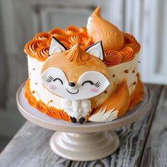 a cake decorated with an orange and white fox