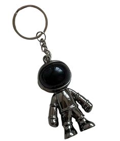 a metal key chain with a black robot on it