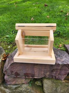 a small wooden stand sitting on top of a rock