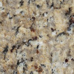 a close up view of the surface of a granite countertop with brown and white speckles