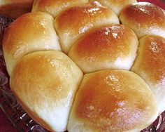 bread rolls sitting in a basket on top of a table