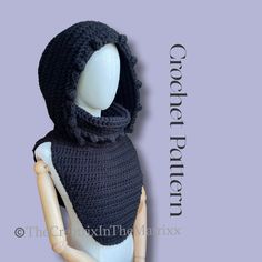 a mannequin wearing a black crochet hooded scarf