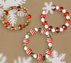 three christmas bracelets on a table with snowflakes