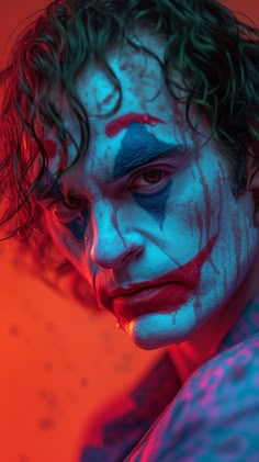 a close up of a person with makeup on and his face painted like the joker