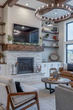 a living room filled with furniture and a flat screen tv mounted on the wall above a fire place