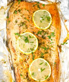 baked salmon with lemons and parsley on foil