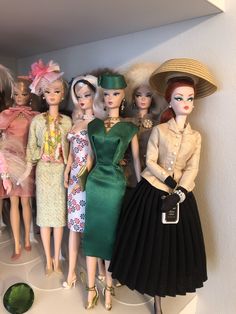 a group of dolls that are standing next to each other