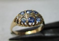 Quality early Edwardian 18ct solid gold diamond and sapphire gemstone ring. The head of the ring is marquise shaped, size 10.0mm{North to South} x 12.0mm{East to West} and is encrusted with rows of light blue sapphire gemstones and diamond gemstone chips, sandwiched between. All of the gemstones are in top condition and exposed to the ring's reverse side to allow the light to shine through to make them glow, also for easy cleaning access. The shank is straight and displays a full striking Birmingham 18ct gold assay hallmark for the year 1903 on its inside circumference. Size 'R-S'{UK}, 9.25{US}. Weighs 3.1 grams. Superb condition throughout with genuine precious gemstones, no repairs and full authentication for its year of manufacture --- a pretty Edwardian example. Luxury Pear-shaped Sapphire Ring With Rose Cut Diamonds, Victorian Multi-stone Yellow Gold Diamond Ring, Antique Oval Sapphire Ring With Single Cut Diamonds, Victorian Gold Sapphire Ring With Diamond, Victorian Sapphire Ring With Diamond In Gold, Antique Multi-stone Sapphire Wedding Ring, Victorian Sapphire Ring With Oval Brilliant Cut, Gold Marquise Diamond Sapphire Ring, Heirloom Marquise Yellow Gold Sapphire Ring