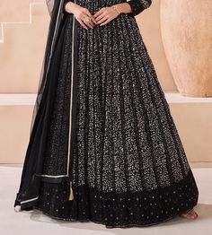 COLOR : Black FABRIC : Top - Pure Georgette, Dupatta - Net WORK : Silk Thread Embroidery, Digital Print, Sequins, Lace Border OCCASION : Party Wear, Festival READY-TO-WEAR : No STITCHING : Available as semi-stitched fabric, can be stitched using standard size option (+$30). Note: There might be a slight color variation due to lighting and flash used during photoshoot. The bright shade seen is the best closer view of fabric's color. Black Bollywood Gown With Long Sleeves, Black Bollywood Long Sleeve Gown, Black Long Sleeve Bollywood Gown, Black Embroidered Long Sleeve Gown, Black Long Sleeve Embroidered Gown, Black Long Sleeve Gown For Festive Occasions, Fitted Floor-length Anarkali Set With Intricate Embroidery, Semi-stitched Black Gown For Eid, Semi-stitched Full Length Embroidered Dress