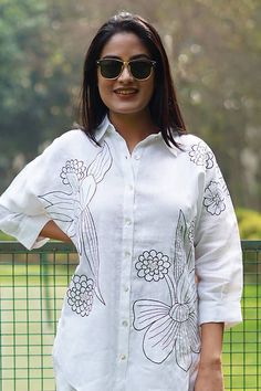 White linen shirt with contrasting flower pattern embroidery. - Aza Fashions White Blouse With Spread Collar For Summer, Summer Floral Embroidered Top With Spread Collar, Summer Top With Floral Embroidery And Spread Collar, Elegant Embroidered Tops With Relaxed Fit, Spring Embroidered Blouse With Spread Collar, Elegant Short Sleeve Top With Chikankari Embroidery, Linen Tops With Floral Embroidery And Short Sleeves, Spring Embroidered Tops With Spread Collar, Spring Embroidered Spread Collar Tops