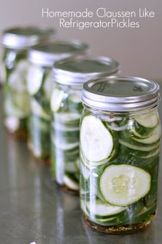 four mason jars filled with sliced cucumbers