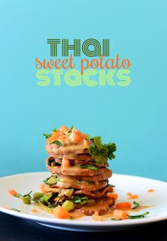 a stack of food sitting on top of a white plate next to a blue wall