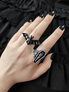 Embrace your gothic style with this striking vampire bat/coffin ring. This unisex ring features intricate metalwork and a vintage design, making it the perfect accessory for Halloween or any gothic-inspired outfit.   Please note that this product includes only one ring. Goth Jelewery, Punk Black Rings For Halloween, Black Punk Rings For Halloween, Punk Black Ring For Halloween, Black Metal Rings For Halloween, Gothic Black Skull Ring For Halloween, Vintage Black Rings For Halloween, Gothic Black Skull Ring, Edgy Black Skull Ring For Halloween