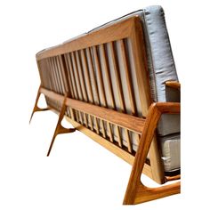 a wooden bench with leather cushions on it