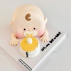 a cake shaped like a baby's head and pacifier