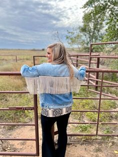 This one is a show shopper! This one is our FAVE! This denim is equipped with the perfect rhinestone fringe! This is a light-washed denim jacket, with two chest pockets, and two side pockets! This jacket is one for the books, and is sure to stand out in a crowd! For our plus sized ladies, sizing up would be ideal! Mariah is wearing XS SIZE CHEST LENGTH SLEEVE WIDTH SLEEVE LENGTH XS 19.75" 24.5" 4.5" 17.75" S 21" 24.5" 4.5" 18" M 21.5" 25.5" 4.75" 18.5" L 22.25" 26" 5" 18.5" XL 22.5" 27" 5" 19" 2 Denim Outerwear With Frayed Hem For Festival, Festival Denim Fringe Outerwear, Fringe Denim Jacket In Medium Wash, Casual Denim Jacket With Rhinestone Fringe For Fall, Rhinestone Fringe, Plus Sized, Washed Denim, Denim Wash, Nice Shoes