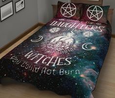 a bed covered in a blanket and pillows with the words witches written on it